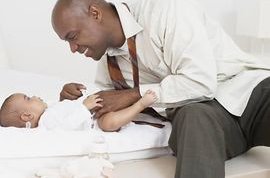 Doctor inspecting newborn
