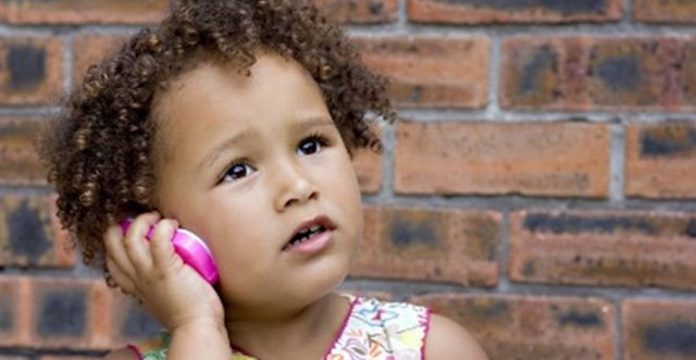 Young girl using toy cellphone